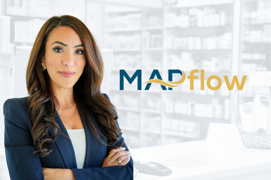 Nardine Nakhla smiling beside the MAPflow logo on a wall.