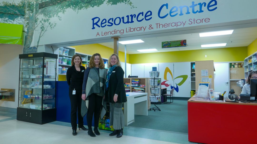 Elaine Tustin, Heidi Wheeler, and Deborah Barton standing at the KidsAbility Resource Centre