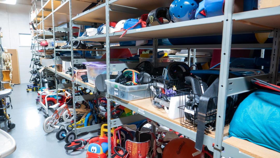 Toys, bikes, and scooters on a shelf