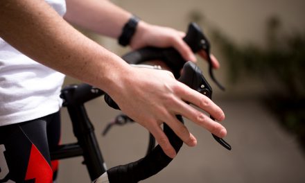 Closeup of Ryan Martin's hand gripping the bike's handlebars