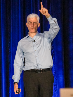 Andrew Winston,author and corporate sustainability consultant, raising a finger while standing