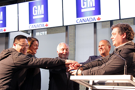 Brian Tossan, Director, Canadian Engineering, GM Canada; Lindsay Farlow, Activator, 2908 at Communitech; Steve Carlisle, President and Managing Director, GM Canada; Iain Klugman, CEO, Communitech; David W. Paterson, Vice President, Corporate and Environmental Affairs, GM Canada, all cheering
