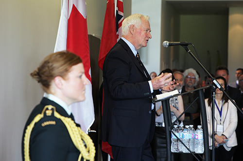 Governor General David Johnston at podium with a guard