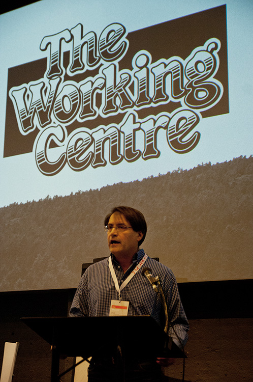 The Working Centre's Joe Mancini at podium
